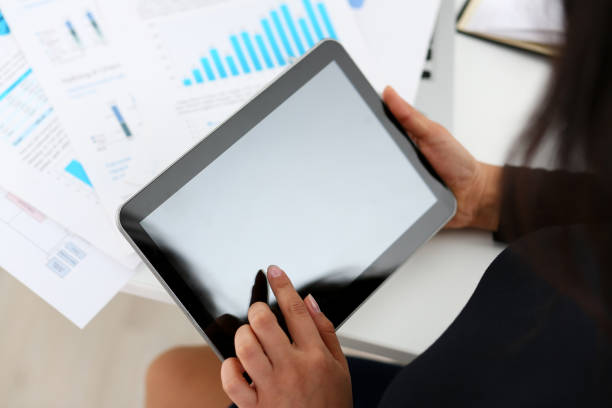 istock businesswoman study documents hold tablet in her hands closeup 1175599955