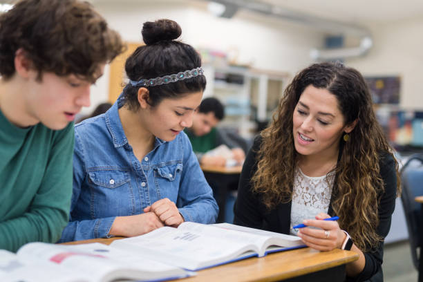 istock teacher helps high school students at their desks 1175603046