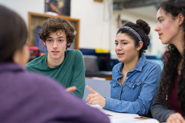 istock High school students work on an assignment together at their desks 1175603048