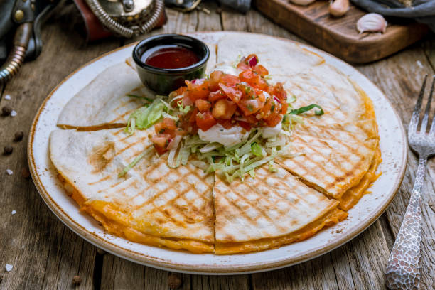 istock Quesadilla with chicken and sauces on old wooden table 1175603102