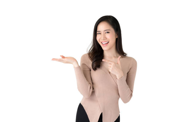istock Smiling Asian woman with open palm 1175607784