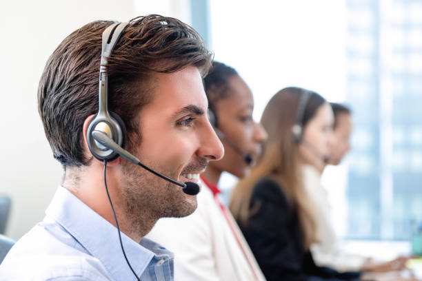 istock Hispanic man in call center office with team 1175607794