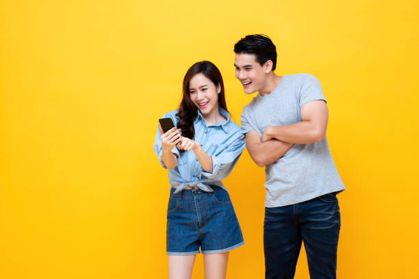 istock Asian couple surfing internet on mobile phone together 1175607813