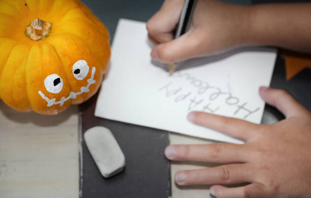 istock Little kid making jack pumpkin and preparing for Halloween eve party. 1175608171