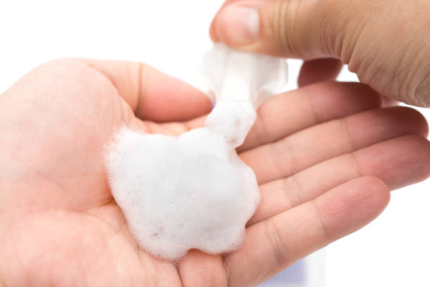 istock man washing hands with soapy liquid on white 1175613313