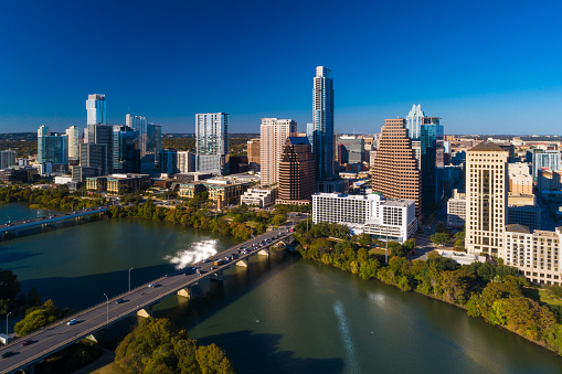 Aerial view of Downtown Austin skyline with Ann W. Richards Congress Avenue Bridge and the First Street Bridge over Lady Bird Lake.