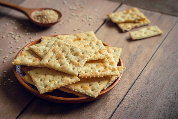 istock Crispy crackers with sesame on wooden plate 1175614970