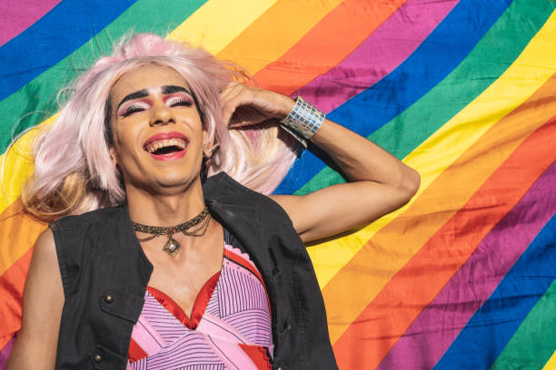 istock Drag queen sunbathing lying on the rainbow flag 1175615215