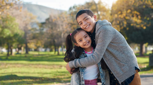 Shot of an adorable brother and sister having a fun day at the park