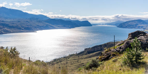 Mountains surrounding Kamloops Lake in central British Columbia Mountains surrounding Kamloops Lake in central British Columbia, Canada on a summers day under a blue sky kamloops stock pictures, royalty-free photos & images