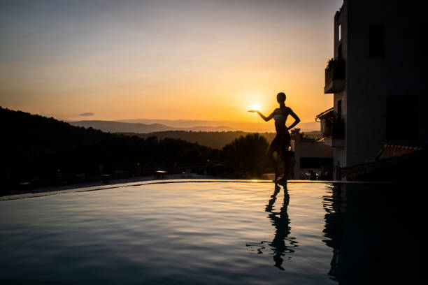 istock Silhouette and reflection of woman holding a sun 1175622843