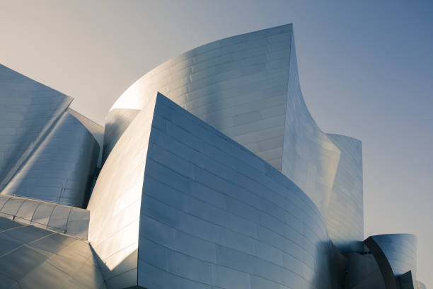 Los Angeles, California - January 7, 2025: Dynamic view of the Walt Disney Concert Hall from an intersection, showcasing its unique architecture and nearby streetscape in Los Angeles.
