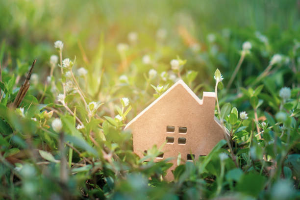 istock Closed up tiny home model on floor or wood board with grass background. Deam life have own house property for living or investment concept. 1175624733