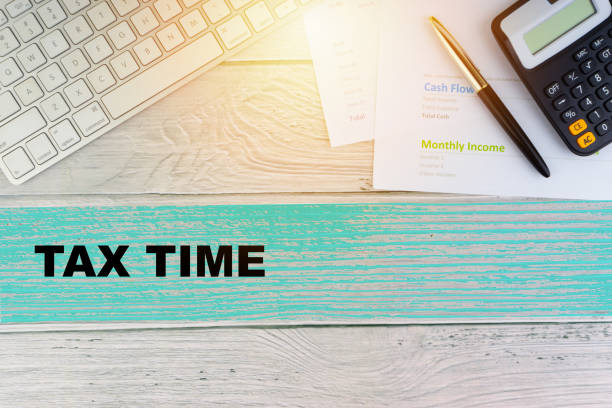 Flat lay view of office table desk. TAX TIME and Copy Space concept Flat lay view of office table desk. Workspace, keyboard, pen and paperwork with words TAX TIME on wooden background. Copy Space concept smart phone telephone research tax stock pictures, royalty-free photos & images