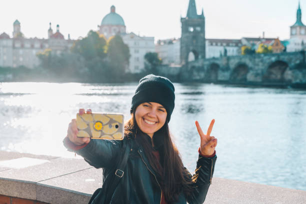 istock woman taking selfie with charles bridge on background 1175636449