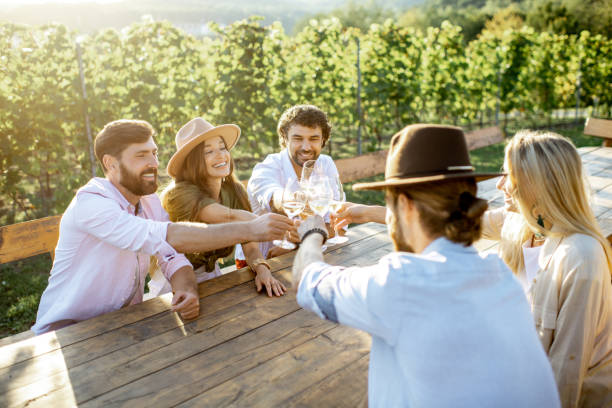 istock Friends drinking wine at the dining table on the vineyard 1175637829