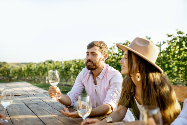 istock Friends drinking wine at the dining table on the vineyard 1175638337