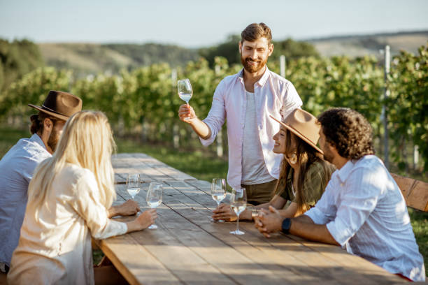 istock Friends drinking wine at the dining table on the vineyard 1175638355