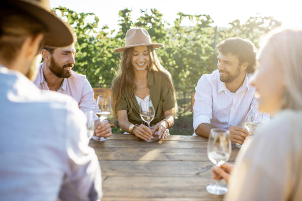 istock Friends drinking wine at the dining table on the vineyard 1175638388