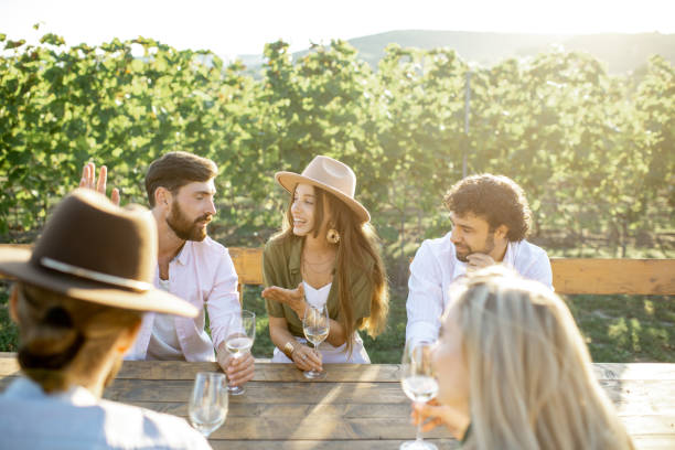 istock Friends drinking wine at the dining table on the vineyard 1175638389