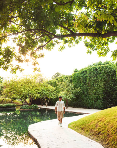 stylish man walking in a garden