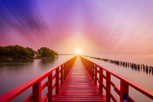 Long Red Bridge sunlight sky tree at beach sea,Red bridge Samut Sakhon Thailand
