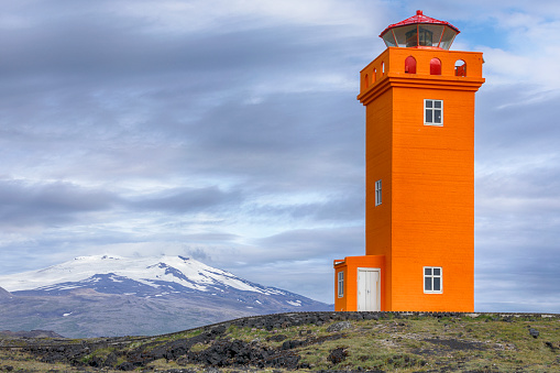 A lighthouse painted a bright orange.