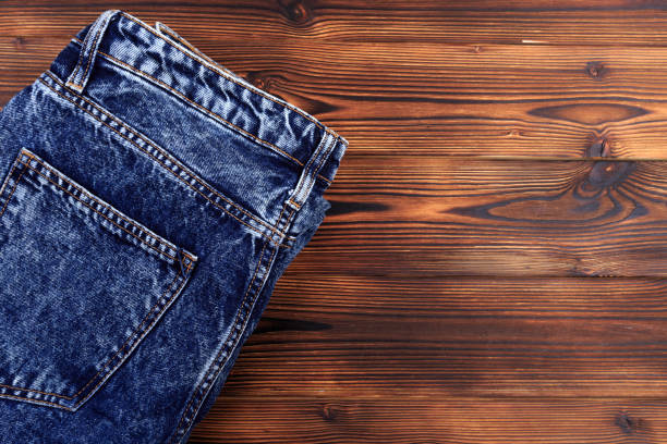 istock blue denim jeans  on wooden background - Image 1175642071