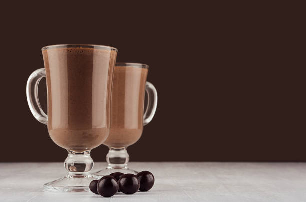istock Elegant hot chocolate with round chocolates on dark brown background, copy space. 1175643976