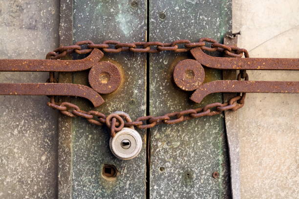 istock Old metallic padlock with rusty vintage chain hangs on old door, security concept 1175645206