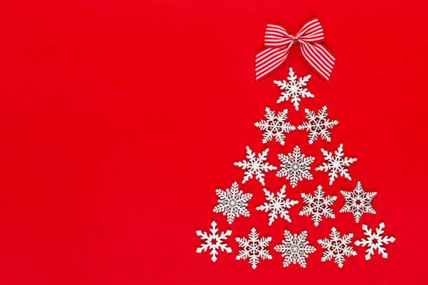 istock White snow flake decoration on red background. Flat lay, top view 1175647409
