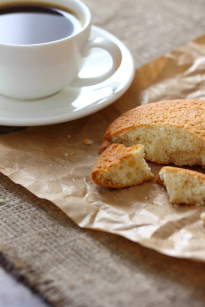istock Oatmeal cookie broken pieces and coffee mug, craft paper, burlap tablecloth. 1175647936