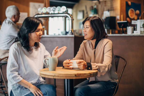 istock Friends drinking coffee in cafe 1175649171