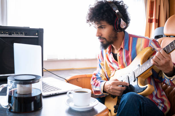 istock Digital Nomad young man guitar player in motorhome 1175650772