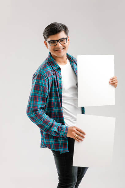 istock Indian/Asian Young Man showing blank signboard on White background 1175650781