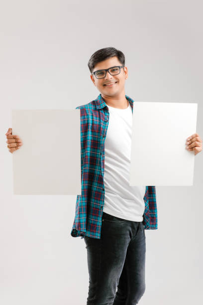 istock Indian/Asian Young Man showing blank signboard on White background 1175650798
