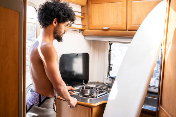 istock Surfer man cooking in motorhome kitchen 1175650988