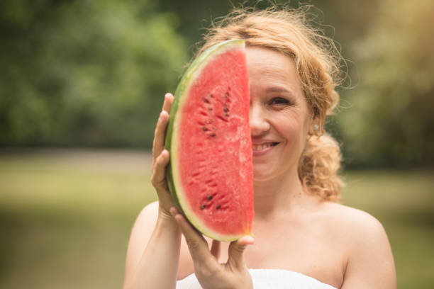 Sweet tastes of summer. Woman in nature holding watermelon.