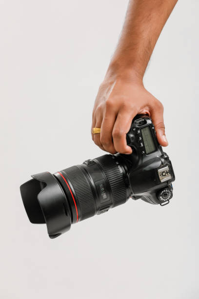 istock Photo camera in hand isolated on white background 1175651600