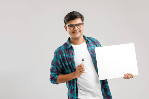 istock Indian/Asian Young Man Writing on blank signboard on White background 1175651640