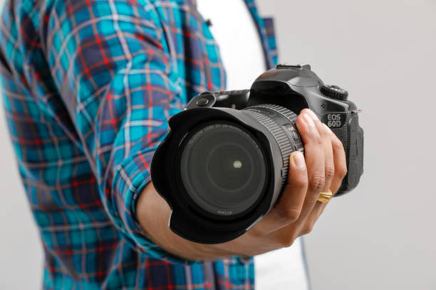 istock Photo camera in hand isolated on white background 1175651659
