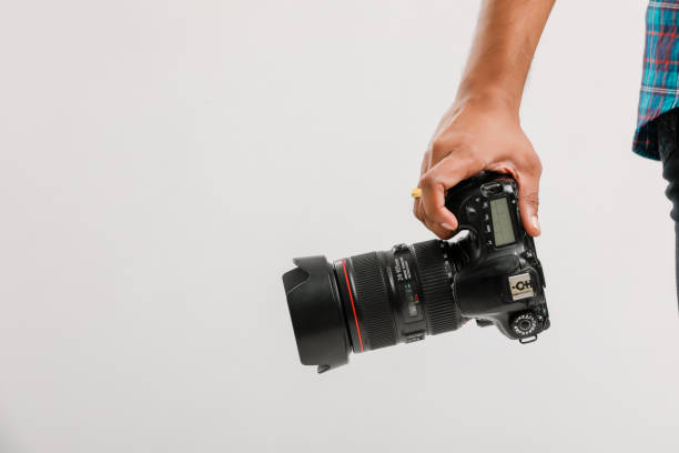 istock Photo camera in hand isolated on white background 1175651824