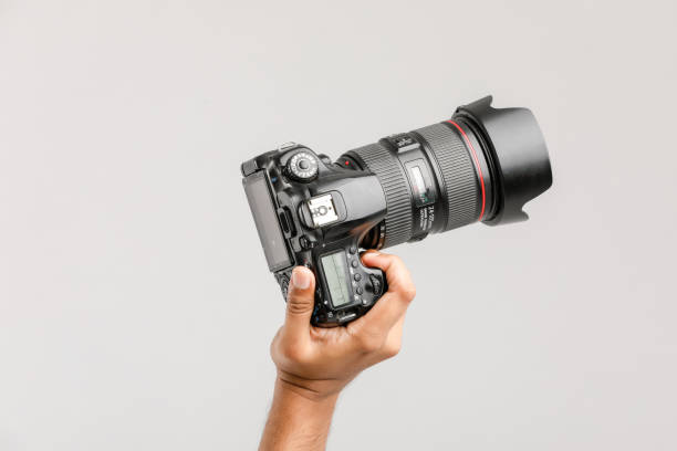 istock Photo camera in hand isolated on white background 1175651853