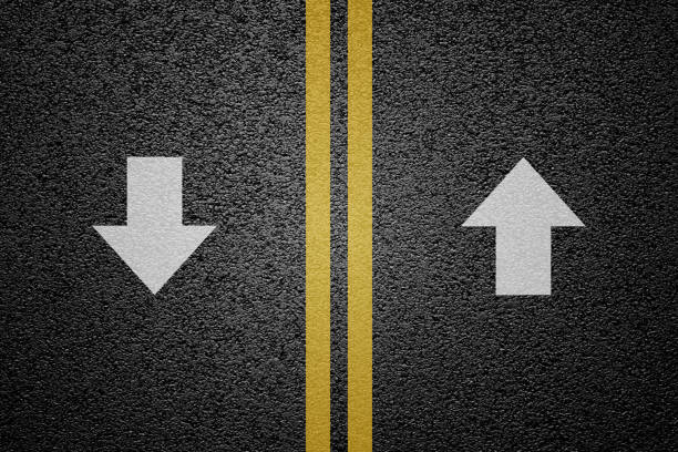 Round trip road sign on asphalt, multiple lane highway