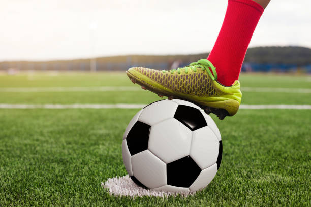 Foot on a football close-up stock photo