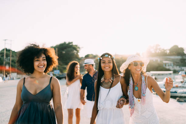 istock Cheerful friends walking on street, pointing at something 1175656206
