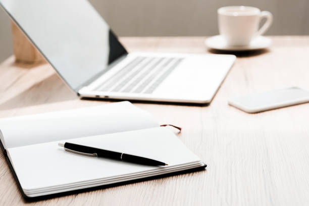 istock selective focus of notebook with pen near gadgets on table 1175656421