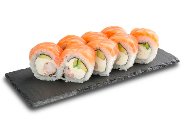 istock Sushi Rolls with salmon, avocado, crab sticks, nori leaf and Cream Cheese inside on black slate isolated on white 1175658036