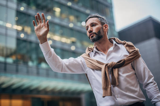 istock Man catching taxi 1175659597