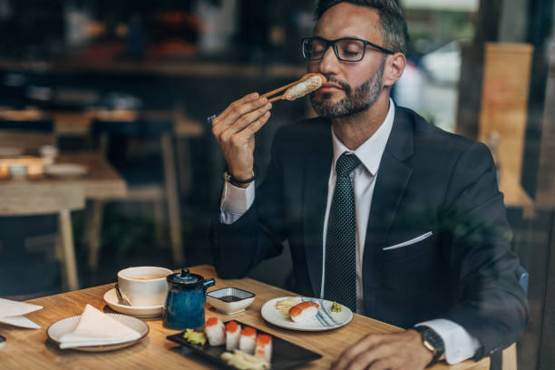 istock Man eating sushi in the restaurant 1175659749